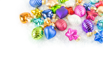 A lot of colourful Christmas balls in the snow copy space