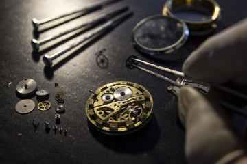 Watchmaker is repairing the mechanical watches in his workshop