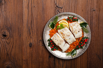 Christmas fish. Roasted cod pieces, served in vegetable sauce.