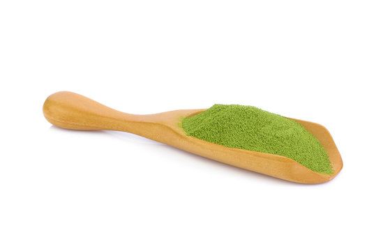green tea powder in wooden scoop isolated on white background