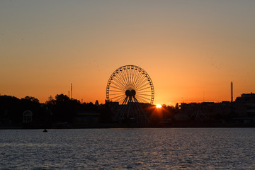 Ferris wheel on the background of sunrise, Berdyansk city