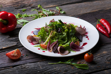  salad with meat on a wooden background