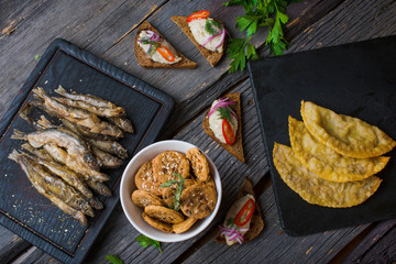  assorted snacks for beer on a wooden background