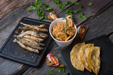  assorted snacks for beer on a wooden background