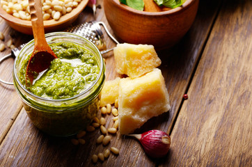 Pesto sauce ingredients and utensils on wood table