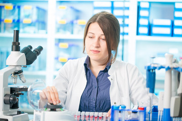 young woman lab assistant in a genetics lab