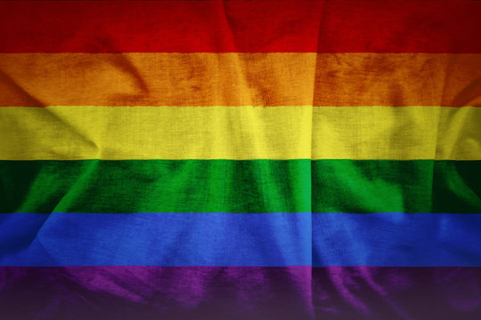 Fabric texture of gay rainbow flag background. A grunge background of the gay flag.