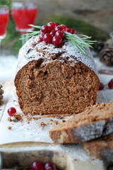 Chocolate cake decorated with powdered sugar and cranberry