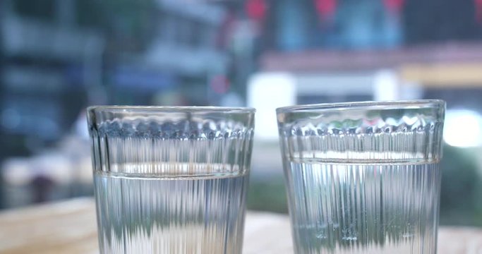 Two glass of water glass with city background