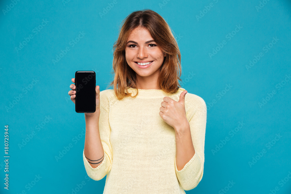 Sticker smiling woman in sweater showing blank smartphone screen