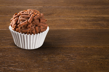 Traditional Brazilian brigadeiro on wood background