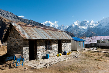 Stone House and Himalayan Mountains