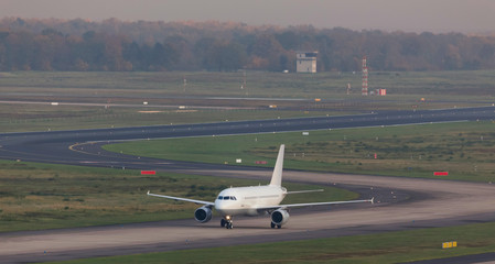 Fototapeta na wymiar passenger airplane on an airport taxiway