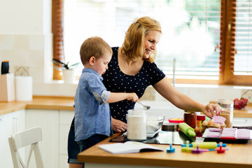 Mother and child preparing cookies