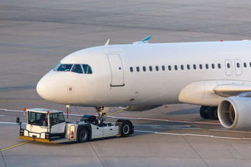 Fototapeta na wymiar passenger airplane beeing towed at an airport