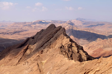 Fototapeta na wymiar Sharp ridge in mountain range of Crater Ramon, Negev desert in Israel.