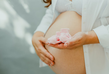 A pregnant woman rests for a beautiful tummy. 