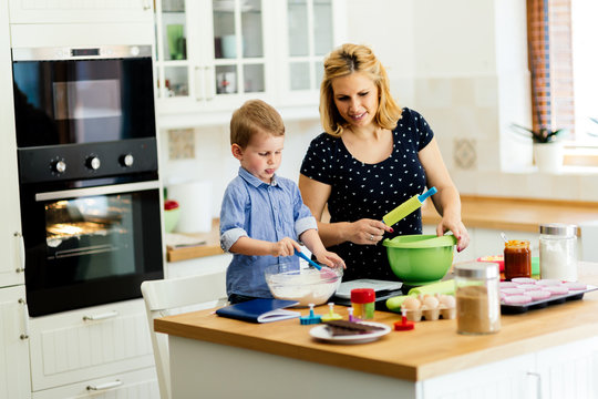 Child helping mother make cookies