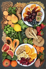 Healthy high fibre dietary food concept including fruit, vegetables, legumes, nuts, whole wheat pasta and whole grain bread rolls. High in antioxidants, omega 3 and vitamins. © marilyn barbone