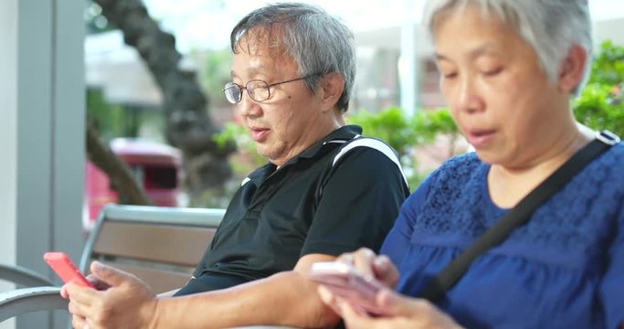 Old couple use of cellphone together