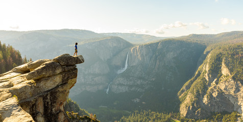 Hiker at the Glacier Point with View to Yosemite Falls and Valley in the Yosemite National Park, California, USA - obrazy, fototapety, plakaty
