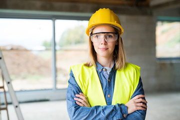 Young woman worker on the construction site.