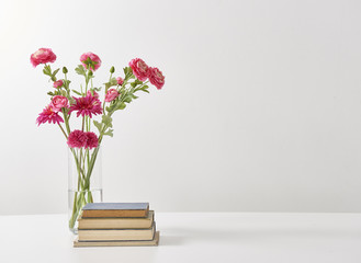 modern vase of flowers book and glass of water