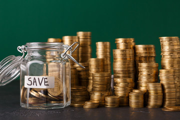 Coins in glass jar for money saving, copy space