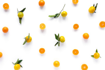Food pattern of fresh fruit in a cut. Tangerines with green leaves. Composition from fruits, top view, flat lay. Citrus fruits background, wallpaper.