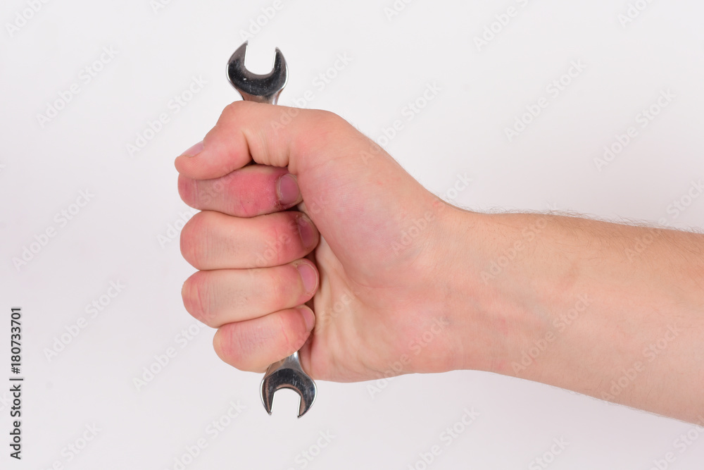 Wall mural Wrench tool in male hand isolated on white background