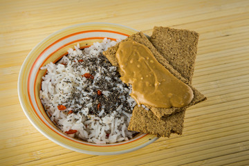 bowl of rice with chia seeds and red goji berries and peanut butter bread