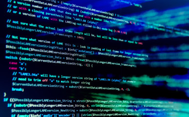 Screen with software developer code. Blur lights.