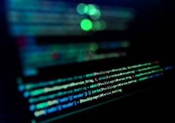 Screen with software developer code. Blur lights.