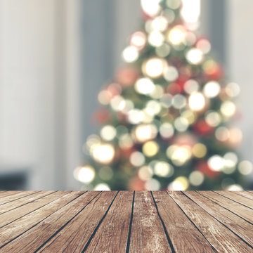 Wood table top on blur Christmas tree in living room