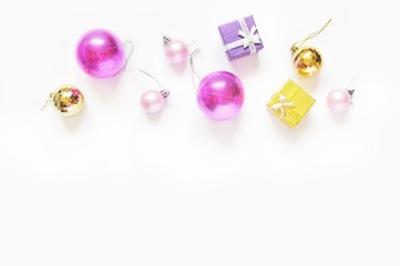 Christmas decoration flat lay photo/ Pink and golden balls, yellow and purple gift boxes. Border, mockup for winter holiday design. Free space for text