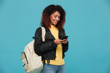 Pleased african woman in leather jacket with backpack