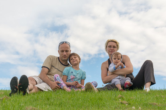 Happy family sitting on the grass