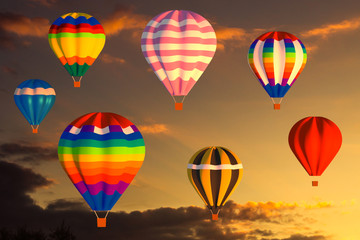 Colorful hot air balloons fly in the sunset sky