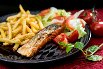 grilled salmon with sauce lemon and tomato