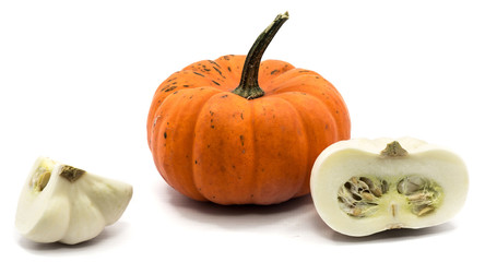 One whole orange pumpkin, white quarter and half isolated on white background.