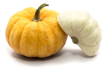 One whole yellow pumpkin, white half isolated on white background.