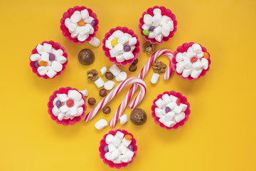 heart made from Colorful lollipops, marshmallow, sweets, nuts and different colored round candy. Valentine's Day. Top view.