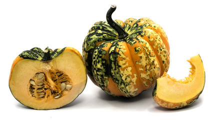 One whole spotted green yellow pumpkin one half and slice isolated on white background.