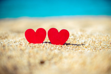 Fototapeta premium romantic symbol of two hearts on the beach 