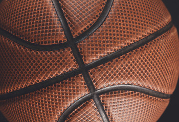 Obraz premium Old basketball ball on black background closeup