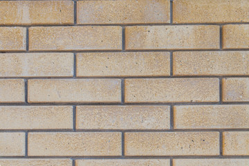 Texture of a light beige brick wall background.