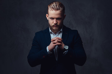 Portrait of stylish blond bearded male dressed in a suit.