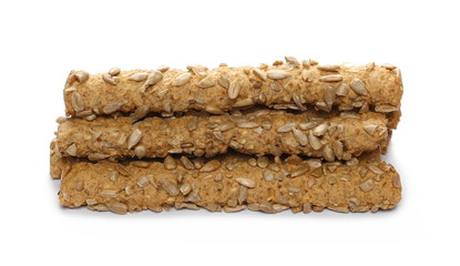 Integral bread sticks with sunflower seeds isolated on white background