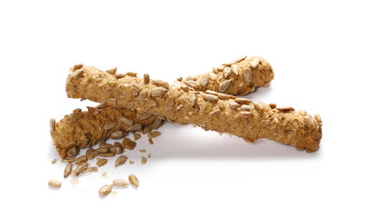 Integral bread sticks with sunflower seeds isolated on white background