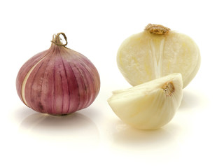 One whole solo garlic and two sliced halves isolated on white background.